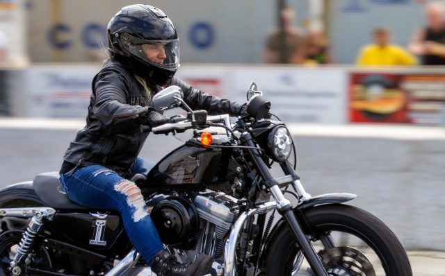 Woman enjoying the ride on a Harley Davidson 48 motorcycle